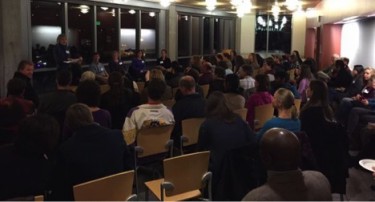 A packed house joins Dean Graumlich and the panelists for 