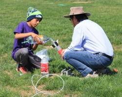 UW space scientist Robert Winglee and a student prepare to launch a bottle rocket. As part of the new effort, more teachers will be trained to do rocketry demonstrations.
