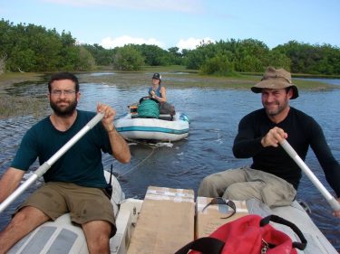 Daniel Nelson (left), Alyssa Atwood (center), and Simon Haberle of Australian National University collect samples from a coastal lake on Isabela Island in 2008. The mangrove trees grow on the edge of the lake and their leaves are preserved in the sediment.