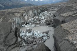 A close-up view of the ice-walled canyon at the terminus of the Kaskawulsh Glacier, with recently collapsed ice blocks. This canyon now carries almost all meltwater from the toe of the glacier down the Kaskawulsh Valley and toward the Gulf of Alaska.