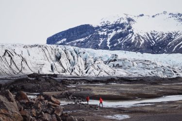 A researcher walking on a glacier.