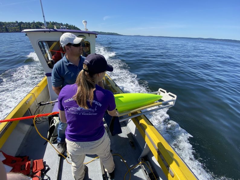 two people launch a Seaglider in Puget Sound.