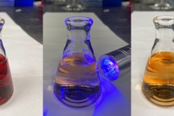Three beakers with different colors of water inside.