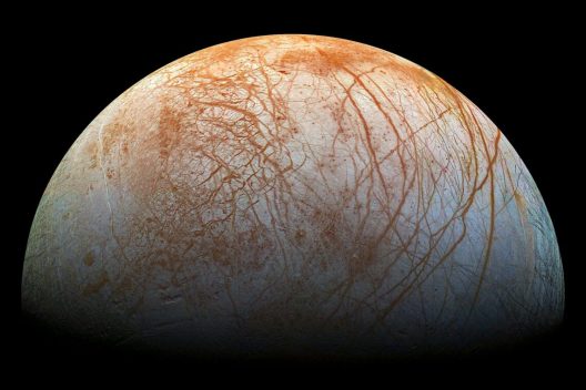 This image shows red streaks across the surface of Europa, the smallest of Jupiter’s four large moons.