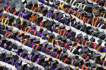 a view from above showing graduates wearing caps and gowns.